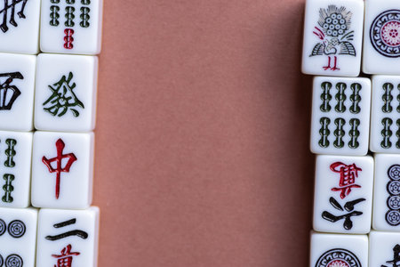 Mahjong tiles lined up on a light backgroundの写真素材