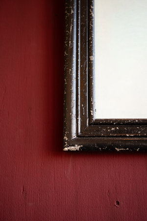 Old picture frames on a red wallの写真素材