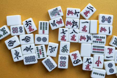 Mahjong tiles lined up on a golden background