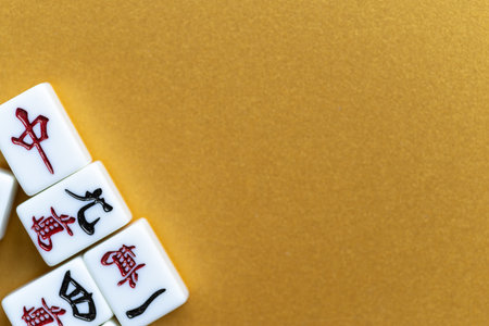 Mahjong tiles lined up on a golden background