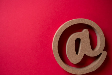 At sign on a red background
