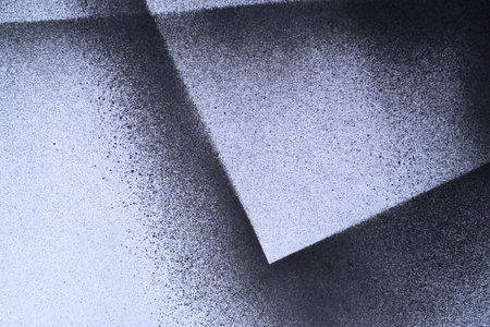 Black spray paint on a white backgroundの写真素材