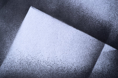 Black spray paint on a white background