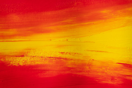 A background of mixed red and yellow paintの写真素材
