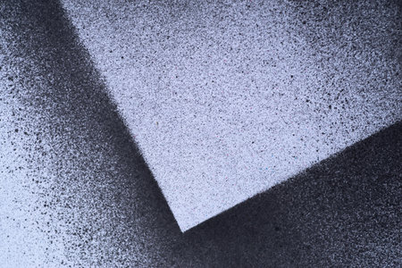 Black spray paint on a white background