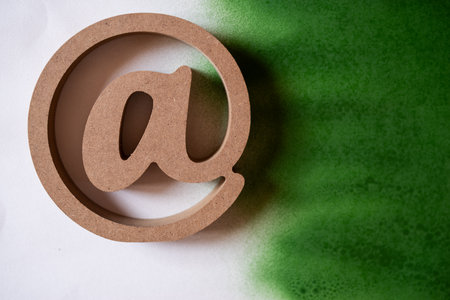 At sign on a white and green backgroundの写真素材