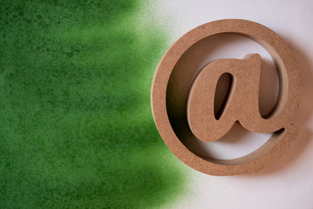 At sign on a white and green backgroundの写真素材