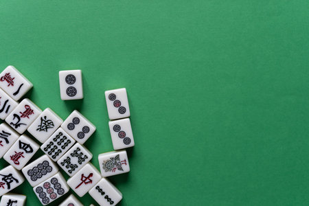 Mahjong tiles lined up on a green backgroundの写真素材