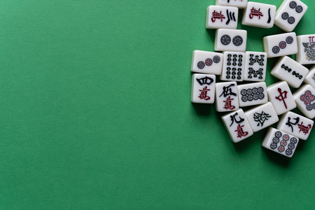 Mahjong tiles lined up on a green backgroundの写真素材