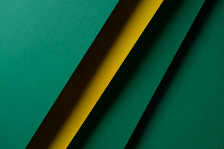 Overlapping green and yellow construction paperの写真素材