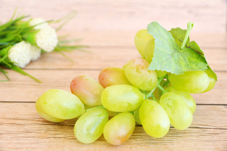 Portion of fresh Green Grapes on vintage wooden backgroundの写真素材