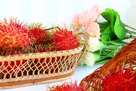 Rambutan in basket on vintage style on retro background.の写真素材