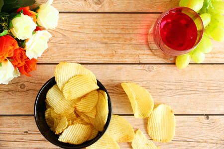 bowl of potato chips on wooden background