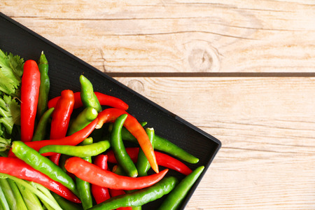 Thai Tom Yam soup herbs and spices, consisting of lemongrass, Kaffir Lime leaves, Galangal, Lemon and Red Chilli on an old wooden table.の写真素材