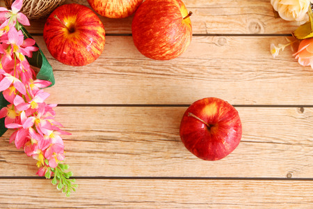 red gala apples with spring fruit tree blossoms on rustic wooden background.の写真素材