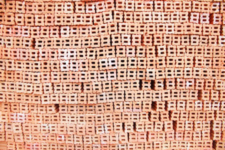 A stack of bricks, bricks are used to build stuff. Shallow focus on front brick.