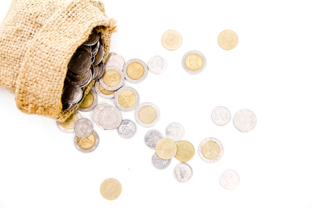 Isolated Jute Money Bag Full of Coins on white background from my idea.の写真素材