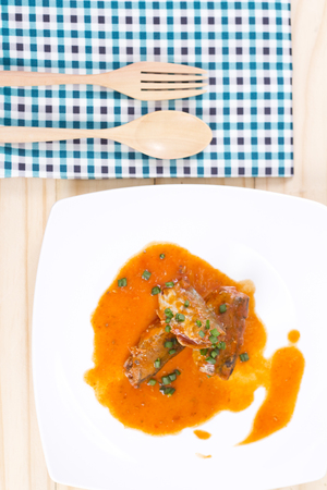 Canned fish fresh food in tomato sauce on wooden background.の写真素材
