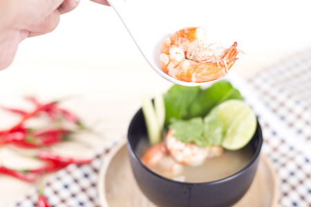 The hot and famous Tom Yum Khung nature of Thailand on wooden background.の写真素材
