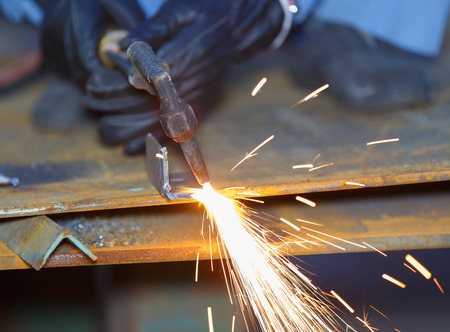 worker use acetylene torch to cutting metal