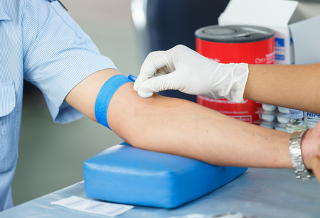 Nurse collecting a blood from a patient for annual checkの写真素材