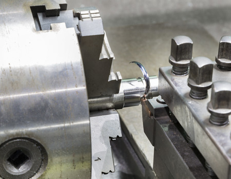 operator grooving steel bar by turning lathe and grooving holderの写真素材