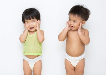 little boy and girl play together on white backgroundの写真素材