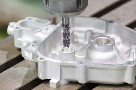 operator milling aluminum automotive part by cabide endmill