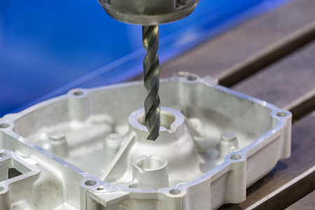 operator drilling aluminum automotive part by carbide drillの写真素材