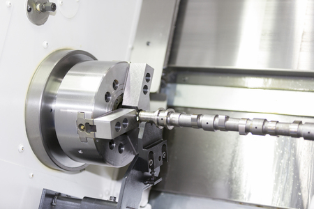 automotive industrial metal work machining process by cutting tool on CNC latheの写真素材