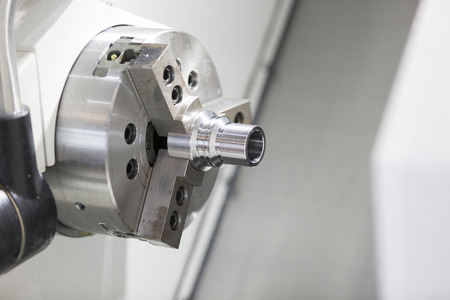 automotive industrial metal work machining process by cutting tool on CNC latheの写真素材