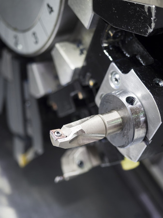 Operator machining automotive part by cnc turning machineの写真素材