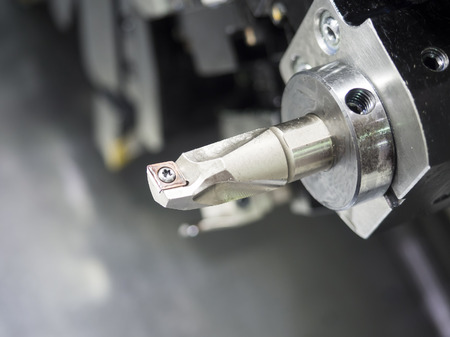 Operator machining automotive part by cnc turning machineの写真素材