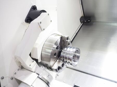 Operator machining automotive part by cnc turning machineの写真素材