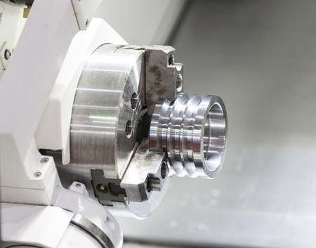 Operator machining automotive part by cnc turning machineの写真素材