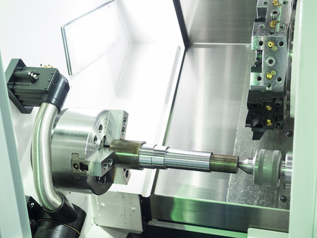 Operator machining automotive part by cnc turning machineの写真素材