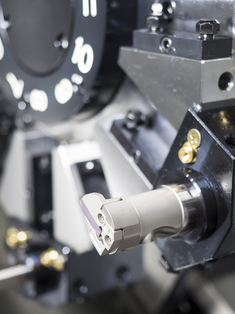 Operator machining automotive part by cnc turning machineの写真素材