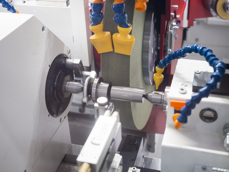 operator grinding mold and die part by CNC universal grining machineの写真素材