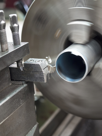 operator turning part by manual lathe machine
