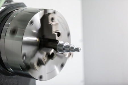Operator machining automotive part by cnc turning machine, high precision part, CNC control,...
