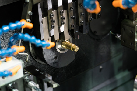 Operator machining automotive part by cnc turning machineの写真素材