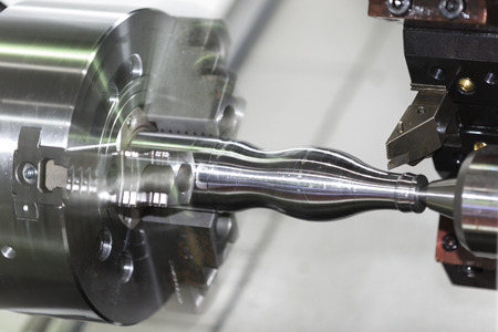 Operator machining automotive part by cnc turning machineの写真素材