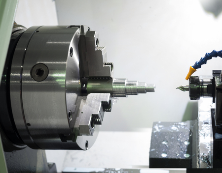 Operator machining automotive part by cnc turning machineの写真素材