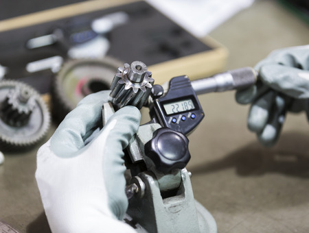 operator inspection high precision automotive part by micrometerの写真素材