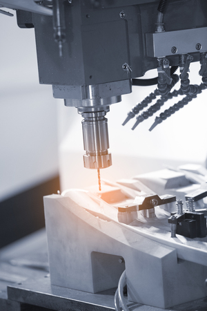 machining precision part by CNC machining centerの写真素材