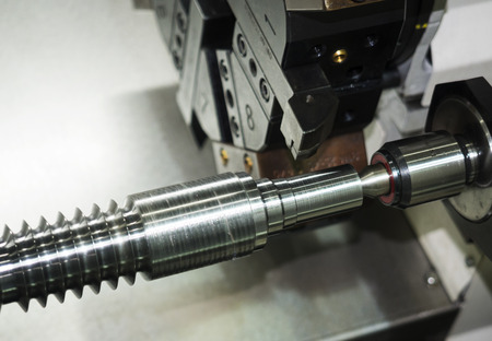 Operator machining automotive part by cnc turning machine, Multi axis CNC turning and milling machine, High precision part manufacturing process with milling by endmill carbideの写真素材