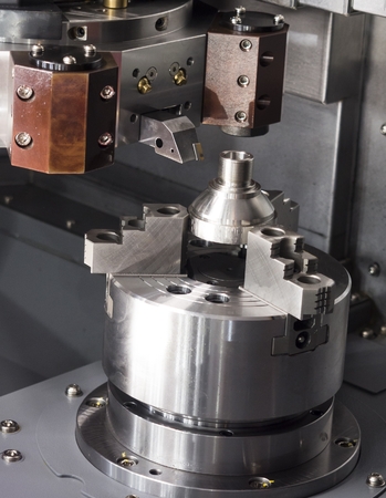 Operator machining automotive part by cnc turning machine, Multi axis CNC turning and milling...