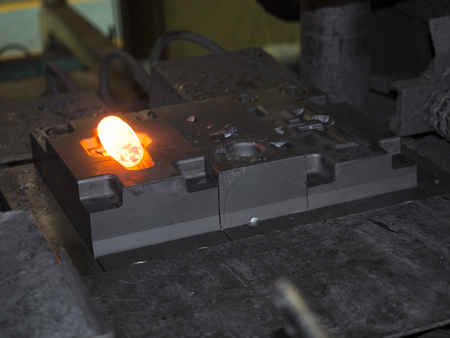 operator forging steel automotive parts by hot forging processの写真素材