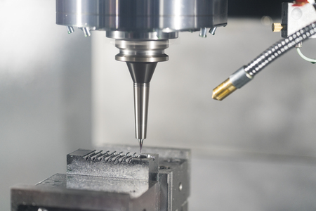 machining precision part by CNC machining centerの写真素材