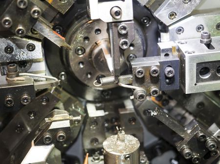 High precision automotive and industrial spring making machine. engineering and technology of industrial manufacturing process for high quality automotive and electric part.の写真素材